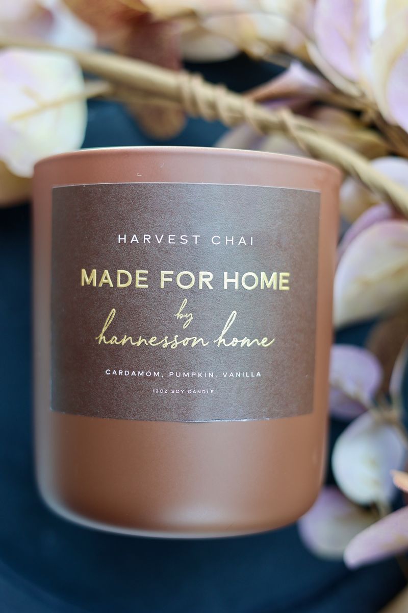 A brown jar candle with a label that reads 'HARVEST CHAI' and 'MADE FOR HOME by hannesson home'.