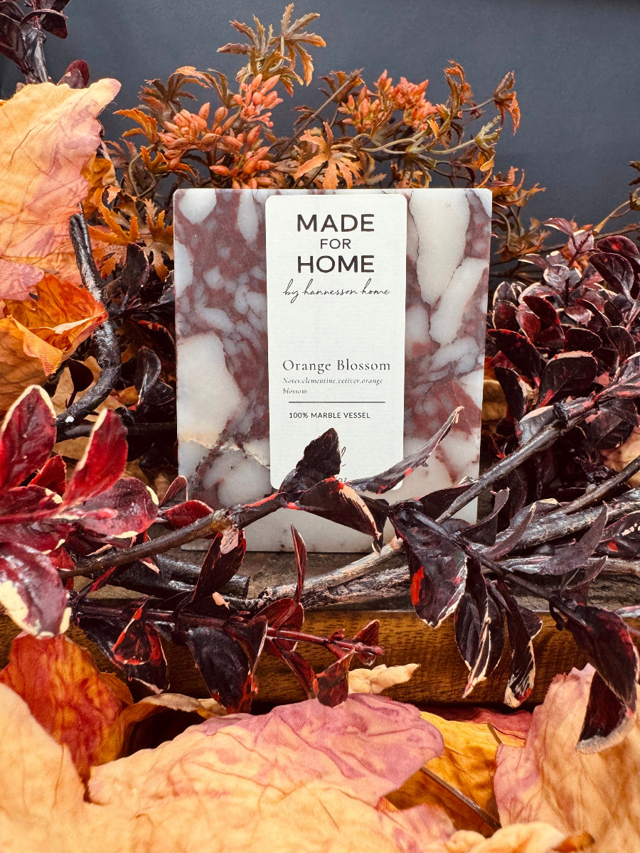 Candle surrounds by leaves
